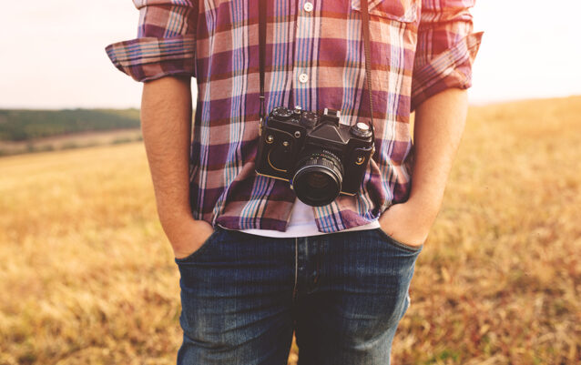 Young Man with retro photo camera outdoor hipster Lifestyle Young Man with retro photo camera outdoor hipster Lifestyle. Film effect